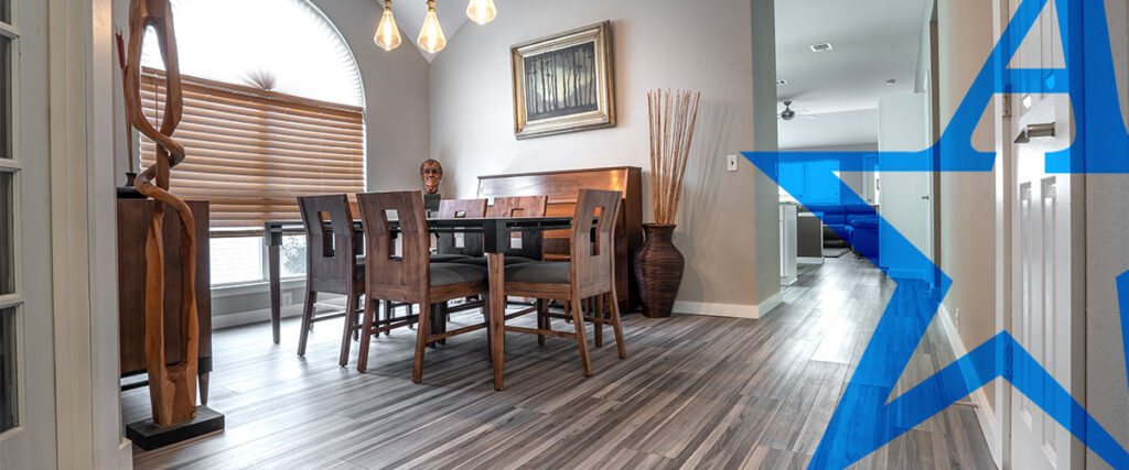 a dining room with a wooden table and chairs | All American Flooring
